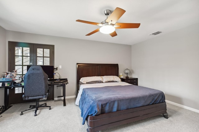 bedroom featuring french doors, ceiling fan, and light carpet