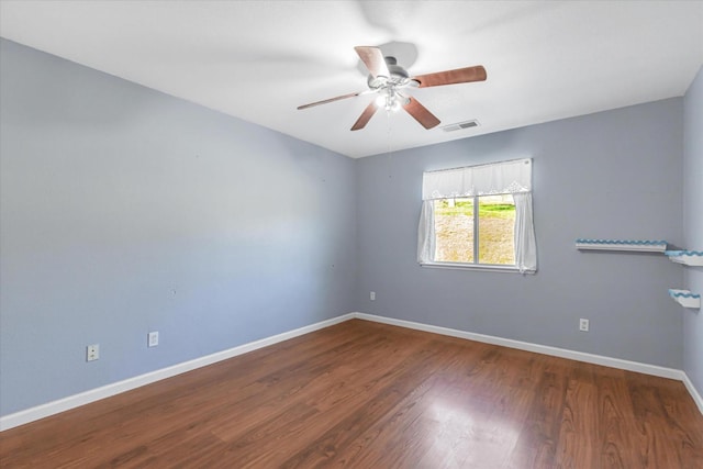 spare room with hardwood / wood-style flooring and ceiling fan