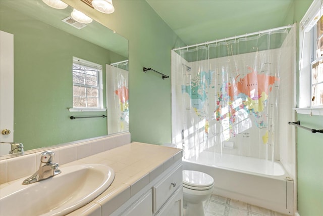 full bathroom featuring shower / tub combo with curtain, vanity, and toilet