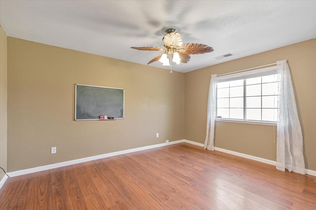 unfurnished room with hardwood / wood-style floors and ceiling fan