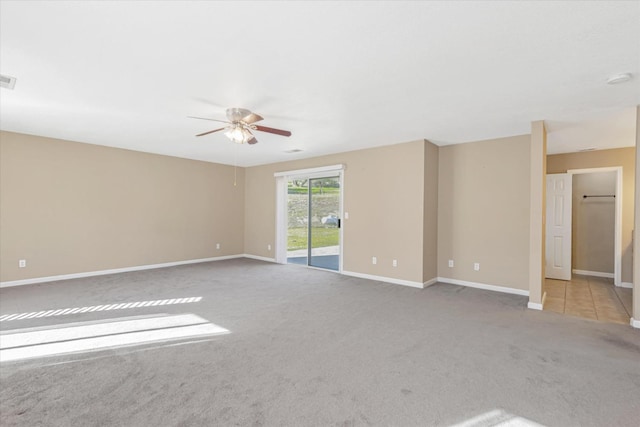 spare room featuring ceiling fan and light carpet