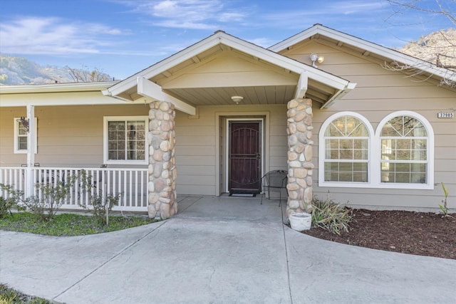 doorway to property featuring a porch