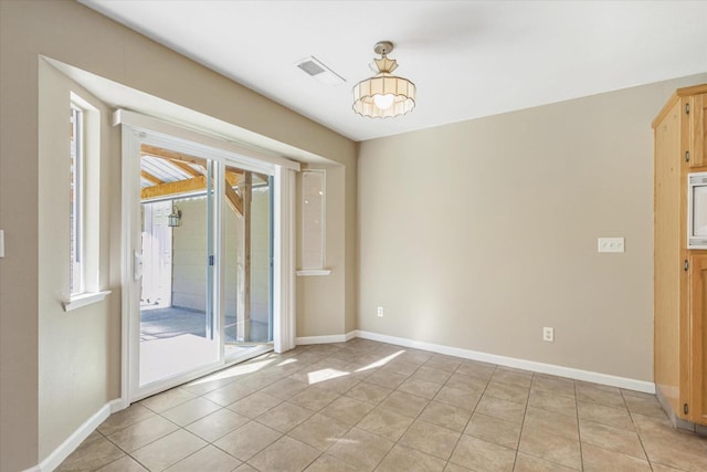 tiled empty room with a wealth of natural light