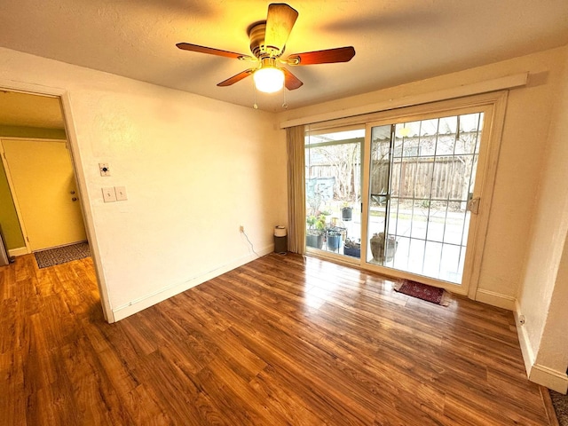 unfurnished room featuring ceiling fan, dark hardwood / wood-style flooring, and a textured ceiling