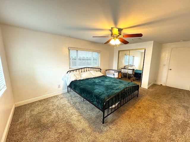 carpeted bedroom with ceiling fan and a closet