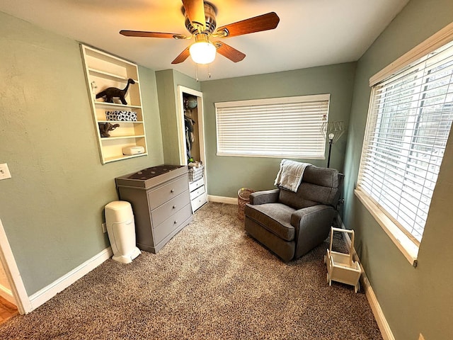 sitting room with carpet and ceiling fan