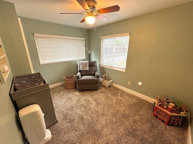 sitting room featuring ceiling fan and carpet flooring