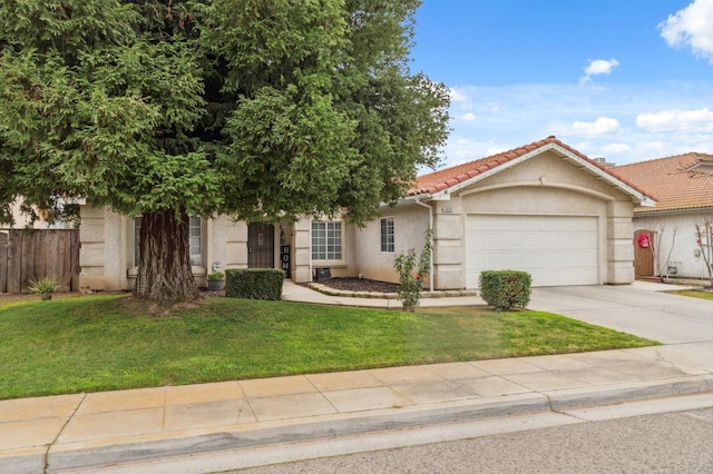 view of front of property featuring a garage and a front yard