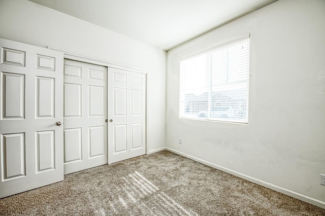 unfurnished bedroom with carpet and a closet