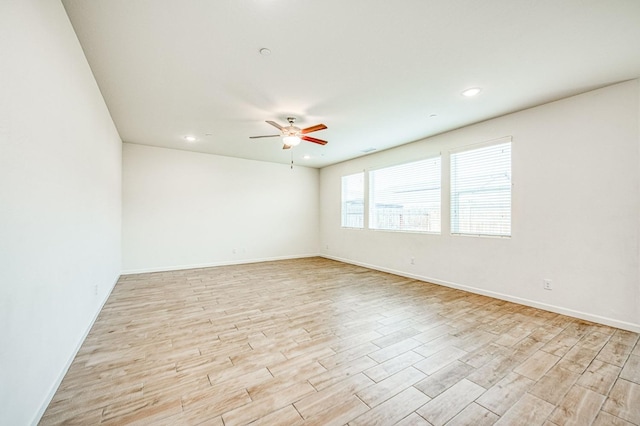 spare room with light hardwood / wood-style floors and ceiling fan