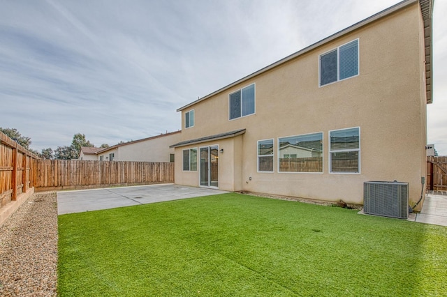 back of house with a yard, a patio area, and central air condition unit