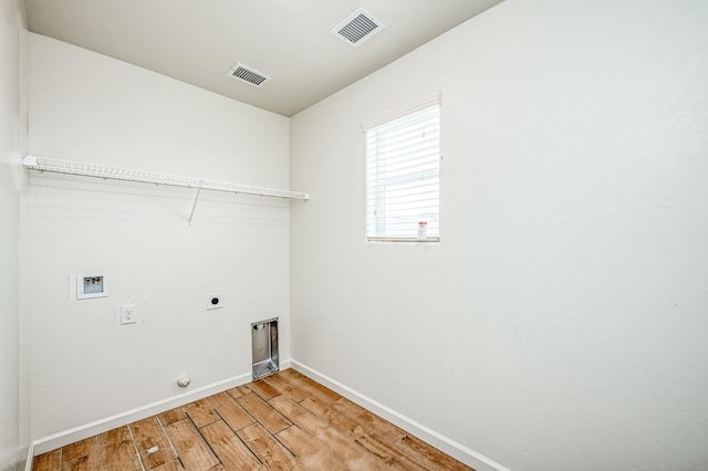 washroom with hookup for a washing machine, wood-type flooring, hookup for an electric dryer, and gas dryer hookup