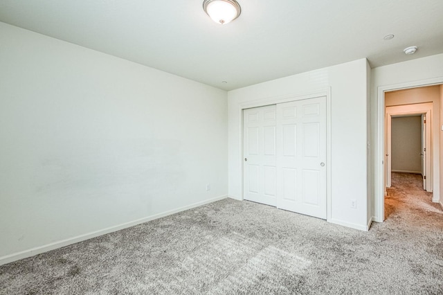 unfurnished bedroom featuring carpet floors and a closet