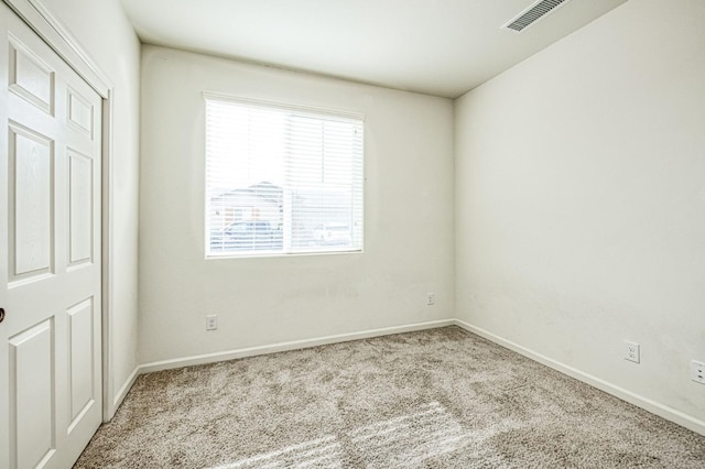 spare room featuring carpet