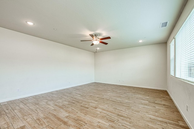 empty room featuring ceiling fan and light hardwood / wood-style flooring