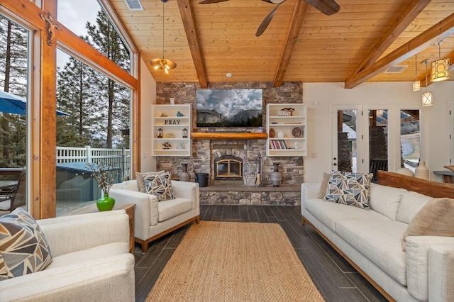 living room with lofted ceiling with beams, ceiling fan, a stone fireplace, and wood ceiling