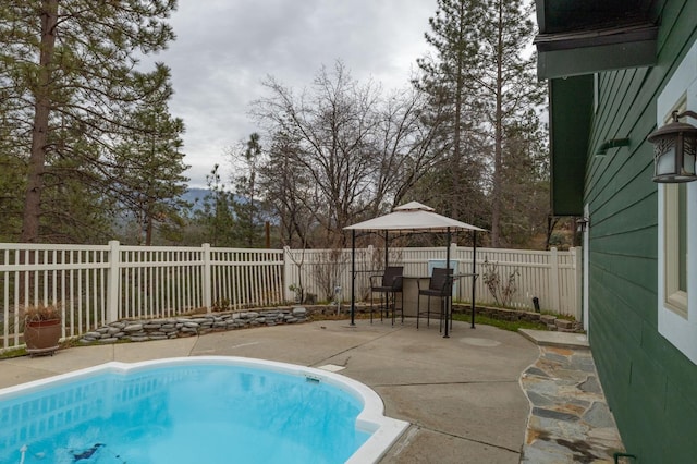 view of swimming pool with a gazebo and a patio area