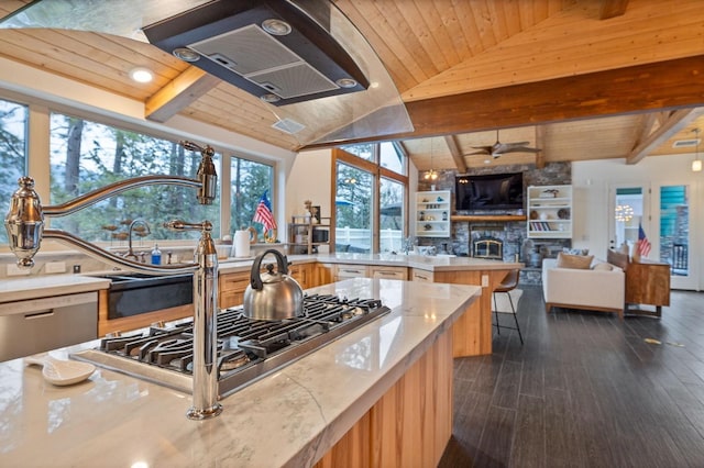 kitchen featuring dark hardwood / wood-style flooring, a stone fireplace, vaulted ceiling with beams, and wood ceiling