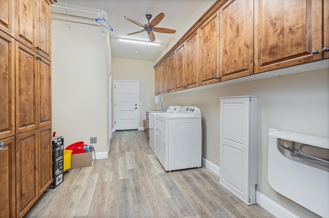 laundry area with cabinets, ceiling fan, separate washer and dryer, and light wood-type flooring