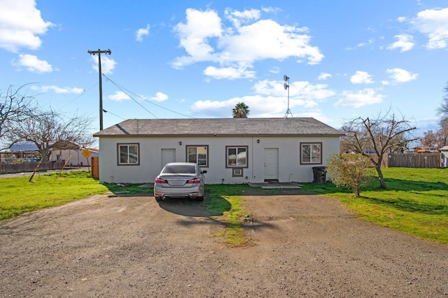 ranch-style house with a front lawn