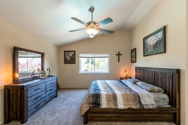 carpeted bedroom with ceiling fan and vaulted ceiling