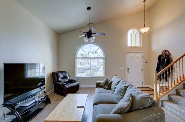 1147 N Carey Ave, Clovis, CA 93611 - living area with stairs, high vaulted ceiling, wood finished floors, ceiling fan, and baseboards