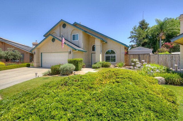 1147 N Carey Ave, Clovis, CA 93611 - view of front of property with stucco siding, concrete driveway, and a garage