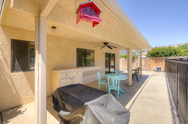 view of patio / terrace featuring a grill and ceiling fan