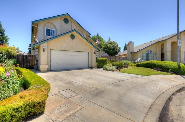 1147 N Carey Ave, Clovis, CA 93611 - view of front of property with stucco siding, driveway, and a garage