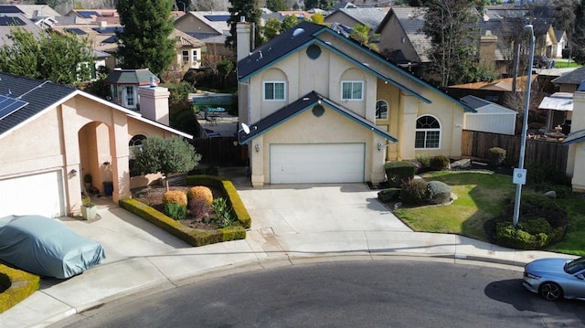 1147 N Carey Ave, Clovis, CA 93611 - view of front facade with concrete driveway, stucco siding, a residential view, and a chimney