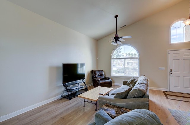 living room with high vaulted ceiling, ceiling fan, and light wood-type flooring