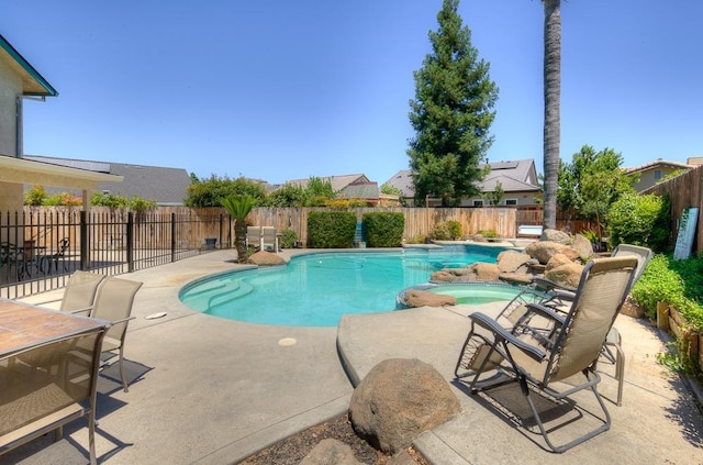 1147 N Carey Ave, Clovis, CA 93611 - view of pool featuring a patio area, a fenced backyard, and a pool with connected hot tub