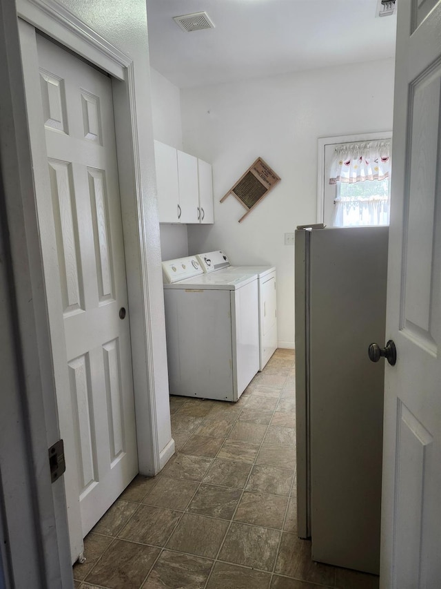 30684 Obanion Ln, Prather, CA 93651 - washroom featuring washer and clothes dryer, dark stone finish floors, and cabinet space