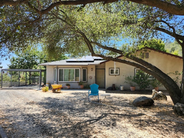 30684 Obanion Ln, Prather, CA 93651 - rear view of house featuring stucco siding and solar panels