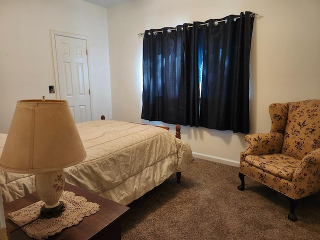 bedroom with carpet floors and baseboards