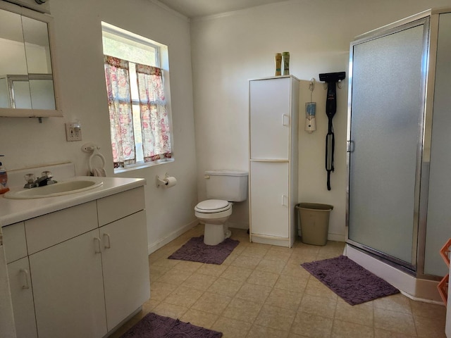 bathroom featuring vanity, toilet, and a shower with shower door