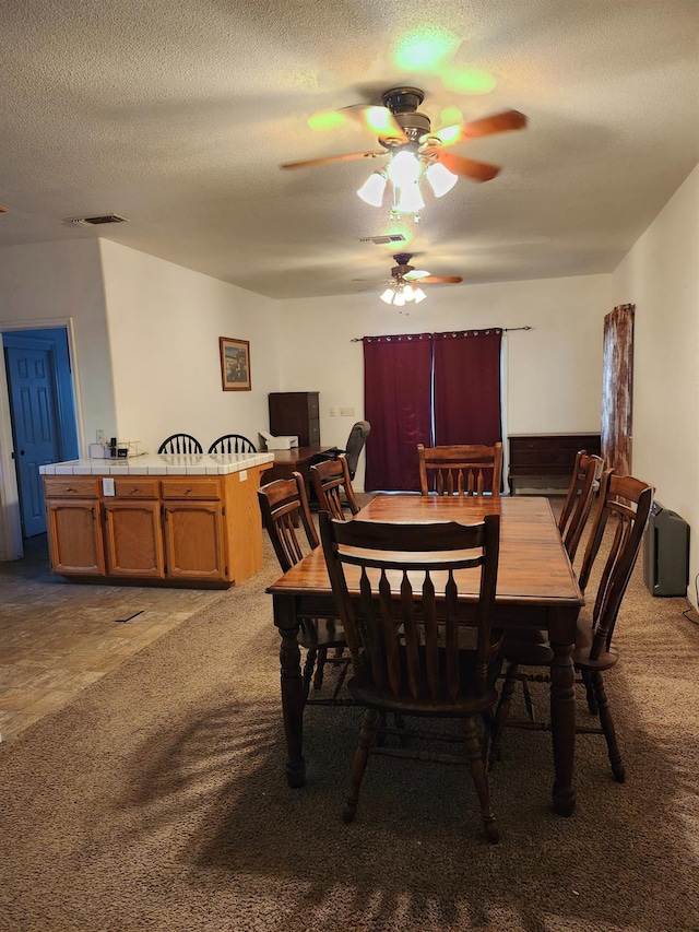 30684 Obanion Ln, Prather, CA 93651 - carpeted dining space with ceiling fan and a textured ceiling
