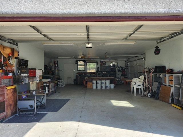 garage featuring a garage door opener and a workshop area