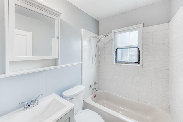 full bathroom with vanity, tiled shower / bath combo, and toilet