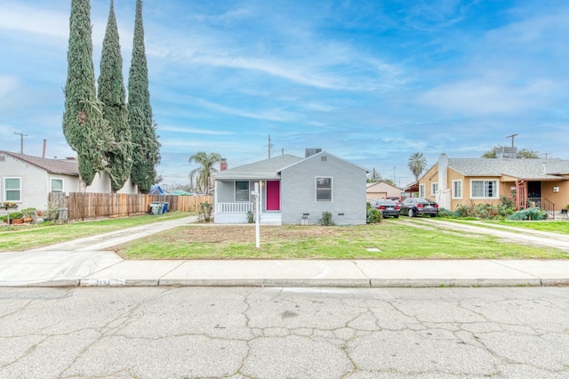 single story home with covered porch and a front yard