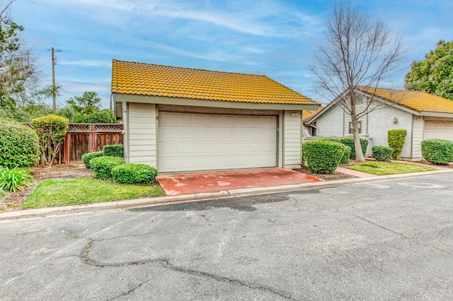 view of front of house featuring a garage and an outdoor structure