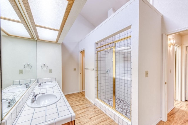 bathroom with vanity, hardwood / wood-style floors, and an enclosed shower