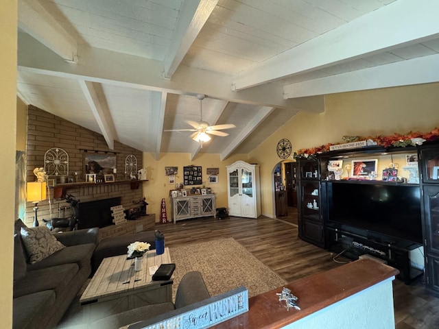 living room with dark hardwood / wood-style flooring, a fireplace, lofted ceiling with beams, and ceiling fan