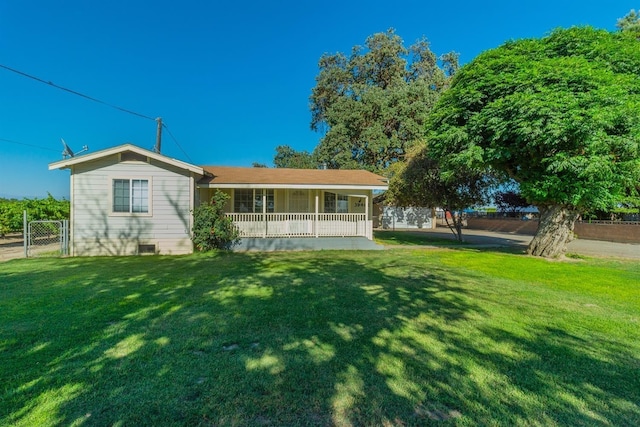 rear view of property with a yard and a porch