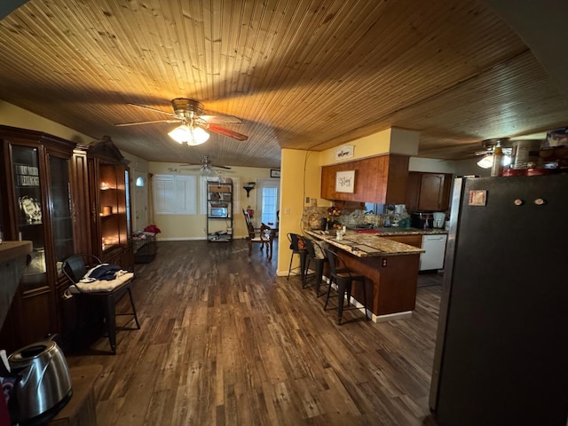 dining room featuring wood ceiling, ceiling fan, and dark hardwood / wood-style flooring