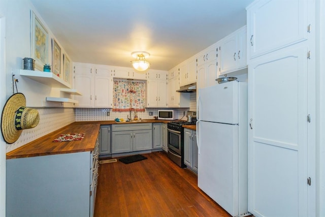 kitchen featuring sink, butcher block countertops, gas range, white cabinetry, and white refrigerator