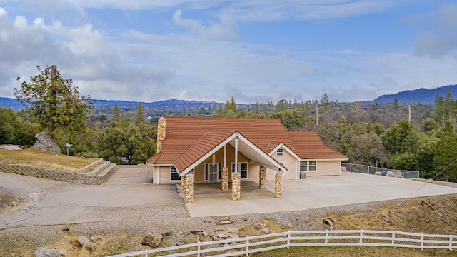 rear view of property featuring a mountain view and a patio