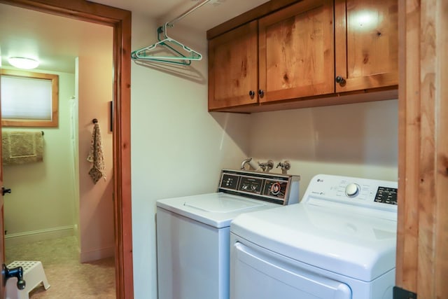 washroom with cabinets and independent washer and dryer