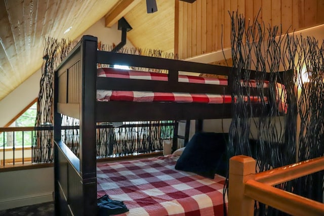 bedroom with wood walls, wooden ceiling, and vaulted ceiling with beams