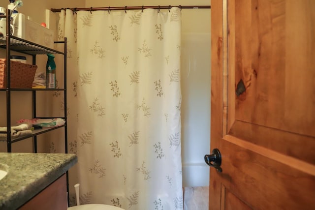 full bathroom with vanity, shower / tub combo, and toilet